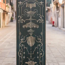 Blue wood panel with hand-painted decorations